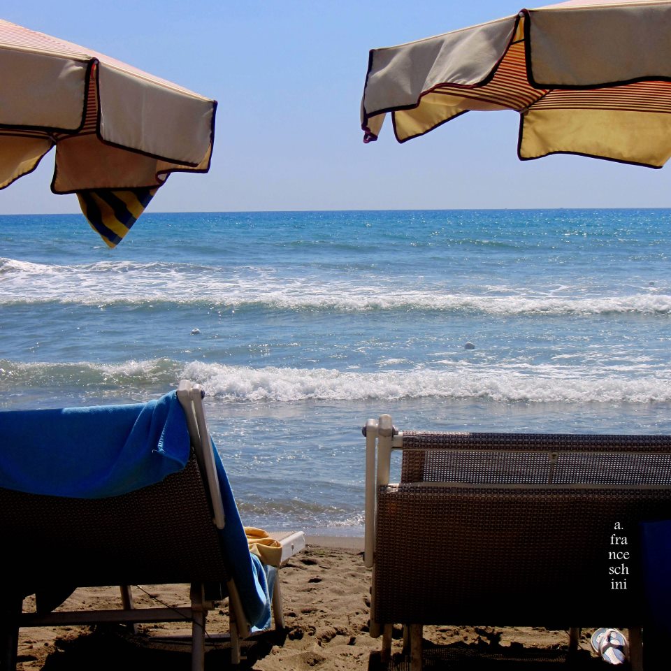 Deck chairs on the beach in Tuscany 