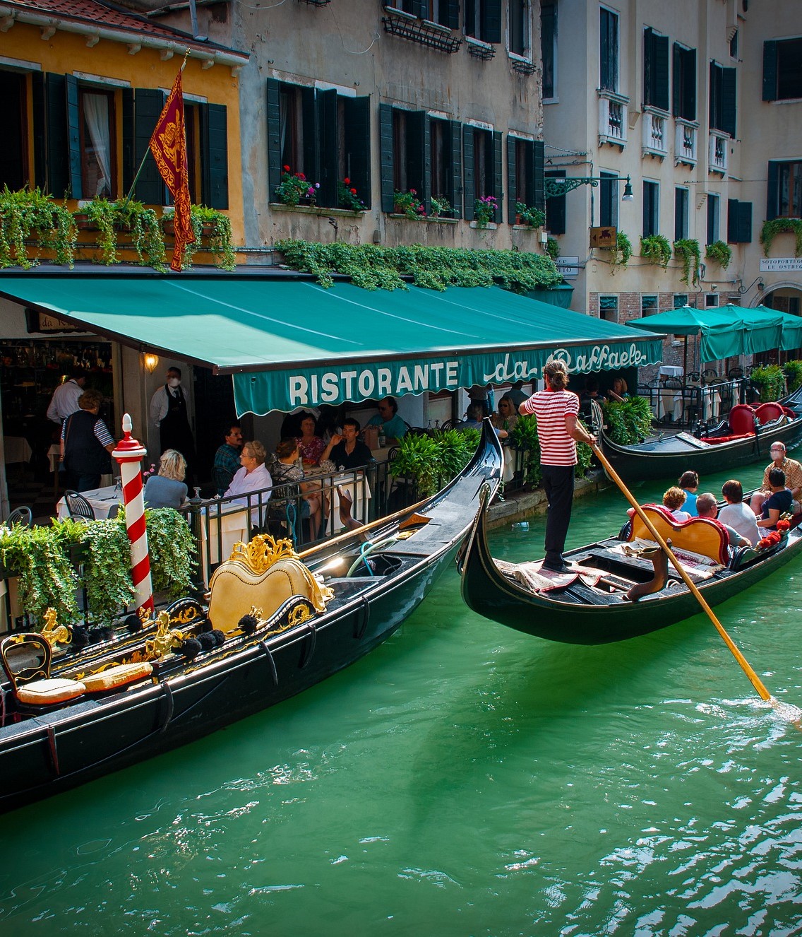 Gondola arrives at a restaurant in Venice Gondola arrives at a restaurant in Venice